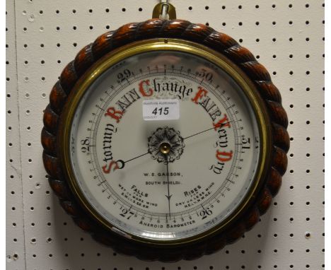 A Victorian oak cased Aneroid barometer, the 19cm circular porcelain dial  inscribed W S Garson, South Shields, ropetwist cas