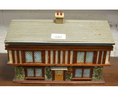 A folk art novelty workbox or humidor, as a timbered house, verso of cover inscribed Xmas 1937