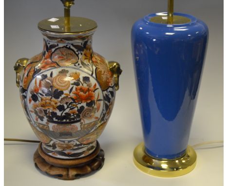 An Oriental baluster shaped table lamp in the Imari palette, lion masks, hardwood base; another (2)