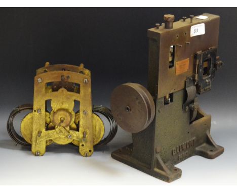 A Gaumont Paris, No 12703, early film projector (incomplete); a brass twin coil clock movement (2)