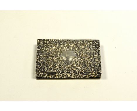 An Edwardian silver rectangular card case/compact, hinged cover and front enclosing a mirror, profusely embossed with scrolli