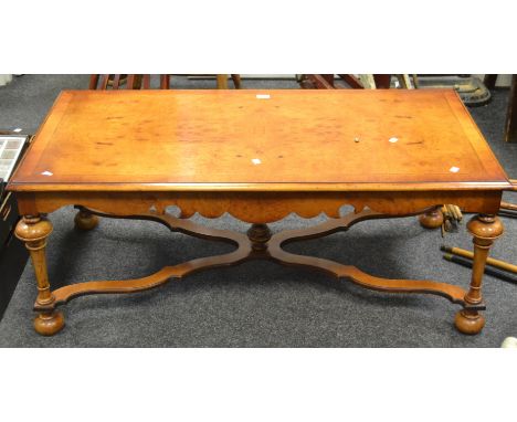 A contemporary half veneered burr walnut coffee table, , turned baluster supports, X frame stretcher, central turned finial, 