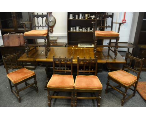 An Ercol drawleaf dining table; a set of six Ercol dining chairs including two carvers 