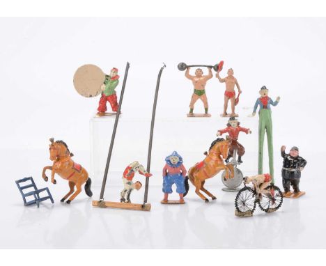 Charbens lead circus figures comprising strong man with bar bells, clown on stilts, clown on monocycle, clown with hoop, clow
