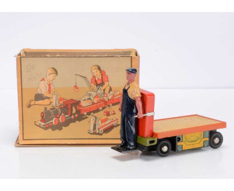 A Lenin Memorial Factory (USSR) Tinplate Clockwork Baggage Cart, with solid plastic Porter figure on a red and yellow cart wi