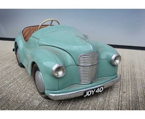 An Austin J40 Pedal Car,  light green pressed steel body, detachable wheels with pneumatic 'Dunlop Cord' tyres, vinyl seating