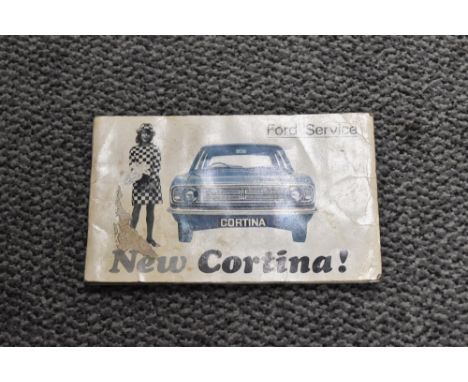 A Ford Cortina service book and an owner manual