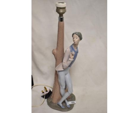 A Nao by Lladro lamp base of a Romeo style lover with rose leaning against a tree, 45cm tall.