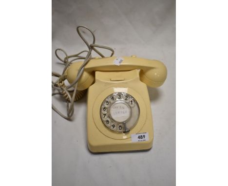A vintage cream plastic Rotary phone.