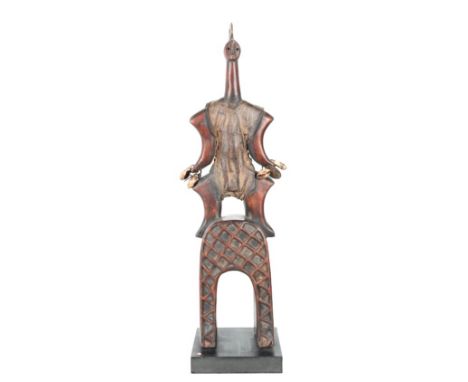 African Hand Carved Wooden Figural Sculpture, with shells, standing on a bridge like form. Size: 5 x 5 x 18 in. Please note t