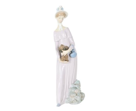 Hard to find, Lladro Porcelain Figure of a woman holding a dog, possibly a Pekingese. Size: 12 x 4 in. Please note that all s