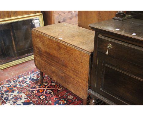 A 19th century oak pembroke table on ring turned legs 