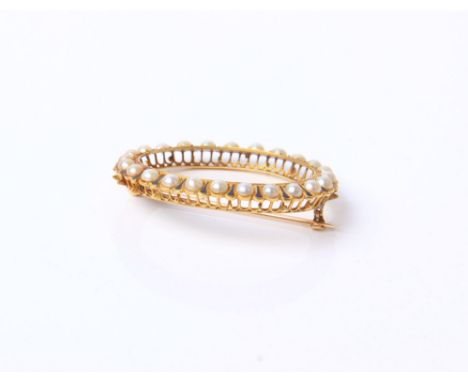 A Victorian gold, half pearl and enamel oval brooch, (lacking the glazed panel) 9.4 g 