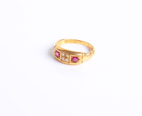 A late Victorian 18 ct gold, ruby and diamond gypsy ring centred with a small old-cut diamond, four stones panel between roun