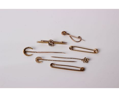 A collection of early 20th century gold pins, including a citrine scroll pin by Murlle Bennett and Co, stamped '9 ct', a Fibu