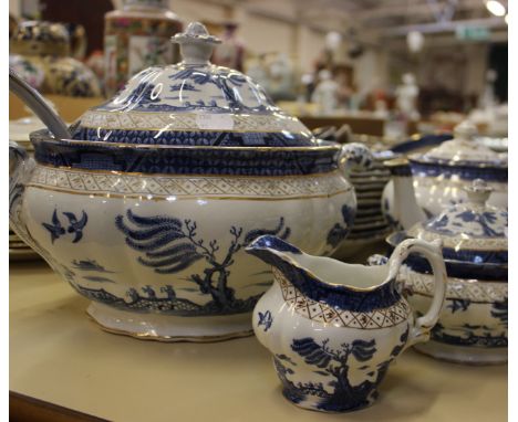 A Booth's China 'Real Old Willow' part dinner service including soup tureen and ladle together with assorted blue and white t