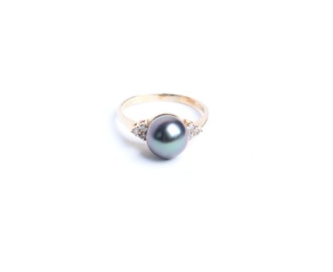 A Continental black south sea/Tahitian cultured pearl ring, the cultured pearl approx 9 mm diameter between small eight cut d