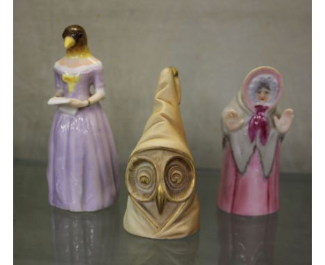 Three Royal Worcester candle snuffers.