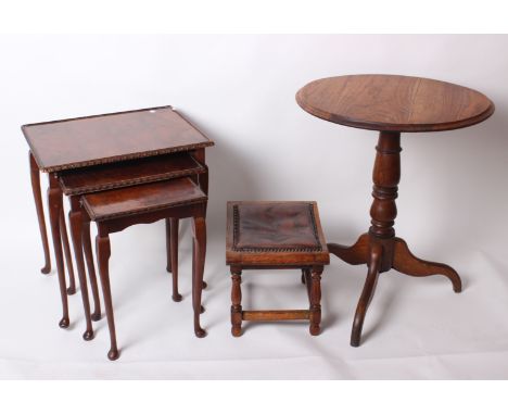 An oak circular top tripod table, a stool and nest of three tables