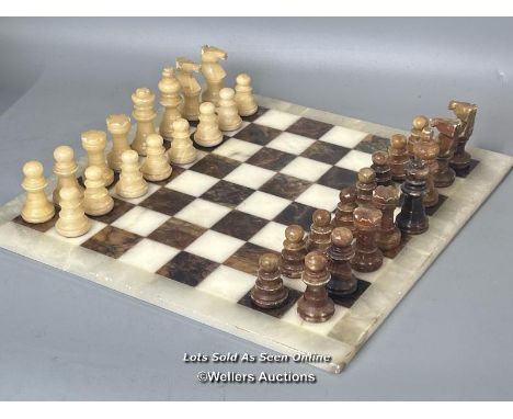Carved alabaster or onyx chess set on marble board, made by C.A.&amp;A. Italy, tallest piece 7.5cm high, board 37 x 37cm / AN