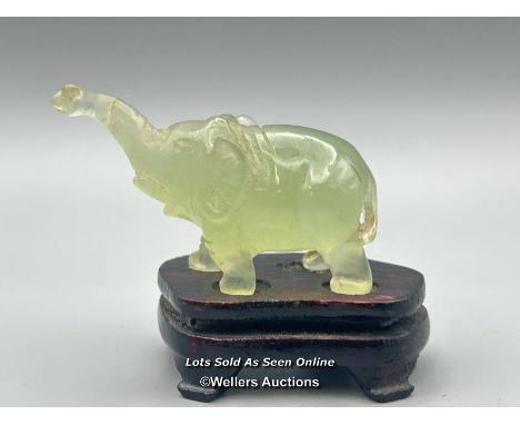 A small carved jade figure of an Elephant on wooden base, 3cm high, 23.5g in fitted box (Lot subject to VAT) / AN7