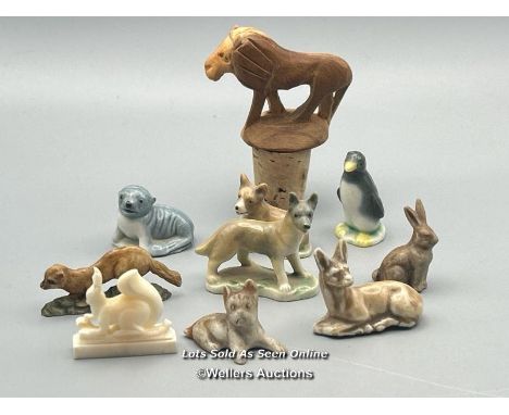 Miniature animal figurines including ceramic Dogs, Seal, Penguin and Deer, with a white carved stone Squirrel and a carved wo