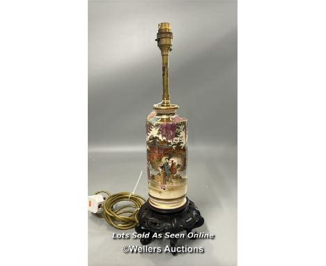 Japanese Satsuma ware lamp on carved base with brass fittings, gilt detail decorated with a village scene, 47 cm high includi
