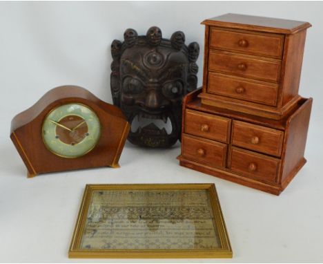 Two miniature chests of drawers, a carved Oriental mask, an alphabetical sampler dated June 8th 1815, framed and glazed (af) 