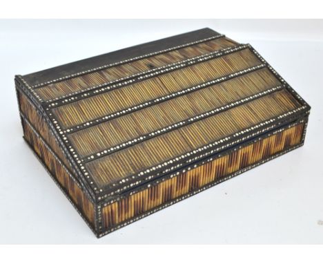 A mid 19th century Anglo-Indian porcupine quill and ivory detailed ebony writing slope of rectangular form, the hinged lid en