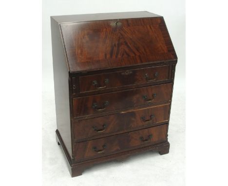 A reproduction crossbanded mahogany bureau, the fall front with fitted interior above four drawers raised on bracket feet, wi