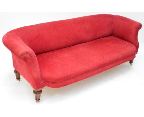 A Victorian upholstered sofa on four mahogany turned and fluted legs on ceramic castors, width 183cm, height 66cm.