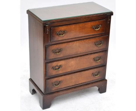 A small reproduction mahogany chest, with short drawer above three long drawers on shaped bracket feet, width 62cm, height 77