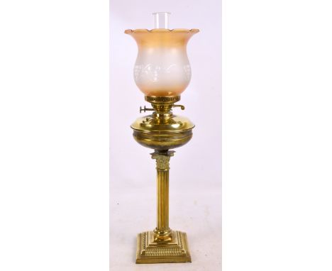 A brass table lamp modelled as a Corinthian column, raised on stepped rectangular base, with brass reservoir and etched amber