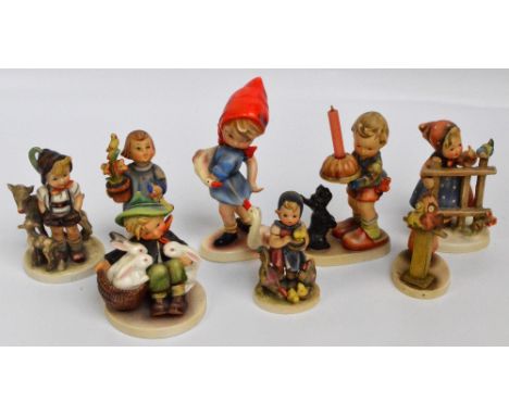 Eight various Hummel/Goebel figures to include a girl at the fence with a bird, a girl with geese, a shepherd boy with sheep 