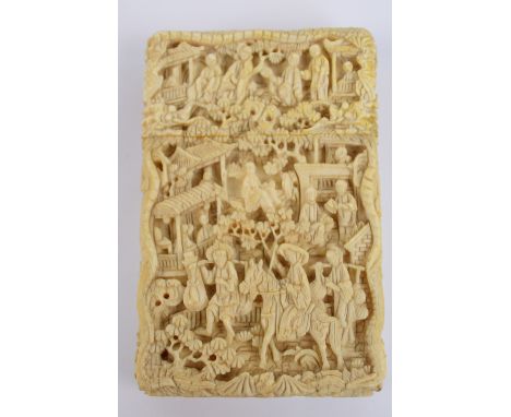 A 19th century Chinese Canton export ivory card case of rounded rectangular form with detailed carving throughout depicting f