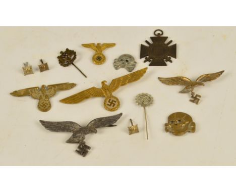 A group of WWII German Nazi badges including skulls and tie pins, also a 1914-1918 cross medallion (some originals).