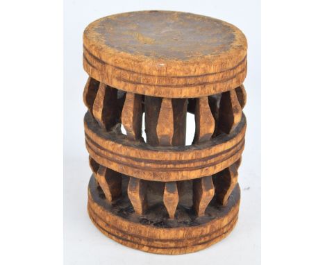 A 20th century African tribal stool with circular top and pierced frame, height 29cm.