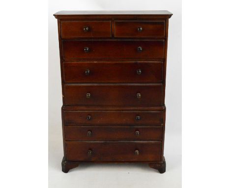 A 20th century miniature stained pine chest on chest raised on bracket feet, height 62.5cm.