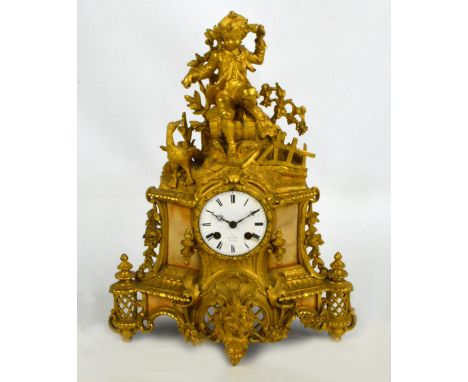 A 19th century French gilt metal and alabaster figural mantel clock with circular white enamel dial set with Roman numerals a
