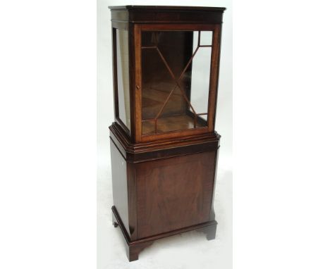 A reproduction mahogany display cabinet, the uppers section with glazed door above a solid door on bracket feet, width 57cm.