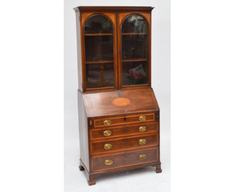 An Edwardian mahogany and satinwood inlaid bureau bookcase with glazed upper section above fall front and four long graduated