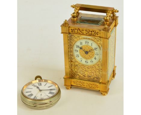 A late 19th century French gilt metal carriage clock with filigree metal front and sides under bevelled glass flanked by flut