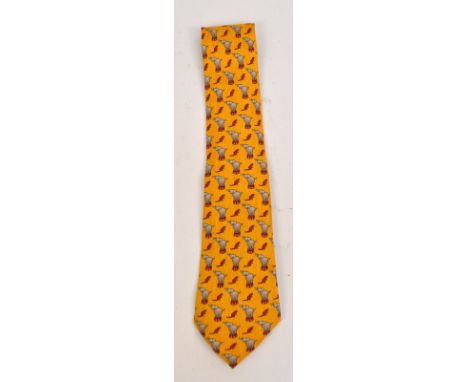 HERMES; an Hermes vintage silk tie in whimsical circus elephant and mouse pattern on an orange ground, in an orange Hermes bo