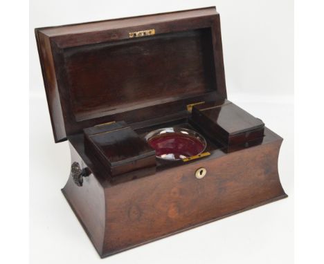 A large 19th century rosewood sarcophagus form tea caddy, the hinged lid enclosing twin lift-out compartments and central gla