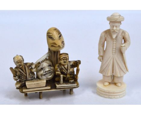 A Japanese Meiji period ivory okimono depicting two seated figures beside a mask, length 6cm, and a late 19th century Indian 