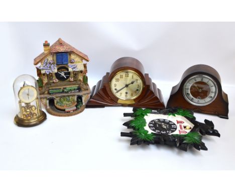 An Art Deco walnut cased mantel clock with silvered dial set with Arabic numerals, width 39cm, an oak dome topped mantel cloc