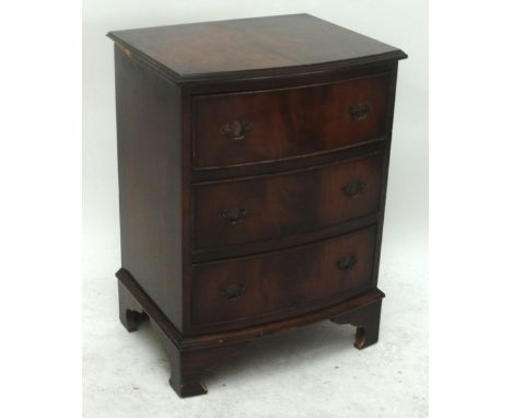 A small reproduction mahogany bowfronted three drawer chest raised on bracket feet, width 52cm.