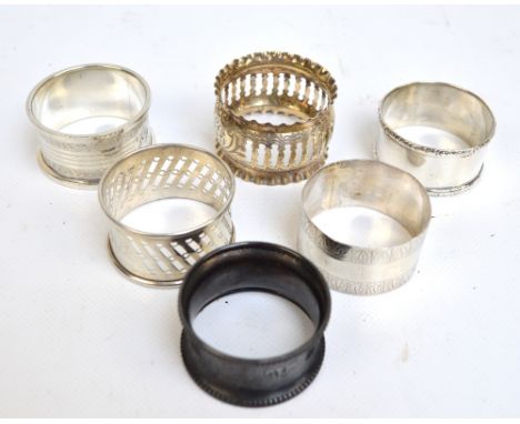 A group of six English variously hallmarked silver napkin rings including plain circular example with pin prick and bright cu