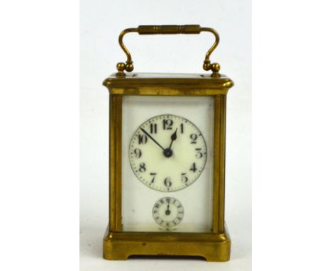 A c.1900 French brass cased carriage clock, the white enamel dial set with Arabic numerals and subsidiary seconds, on a brack