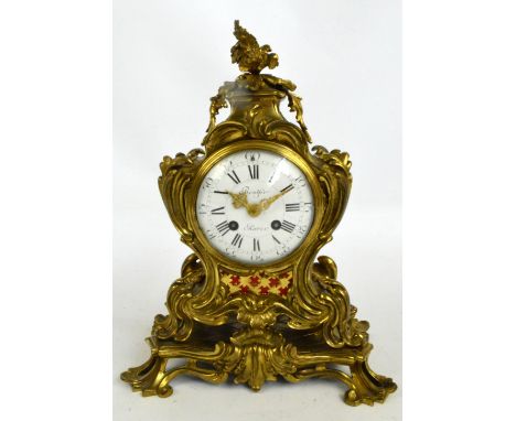 A 19th century French gilt metal mantel clock, the white enamel dial set with Roman numerals inscribed "Brulfer, Paris", hous